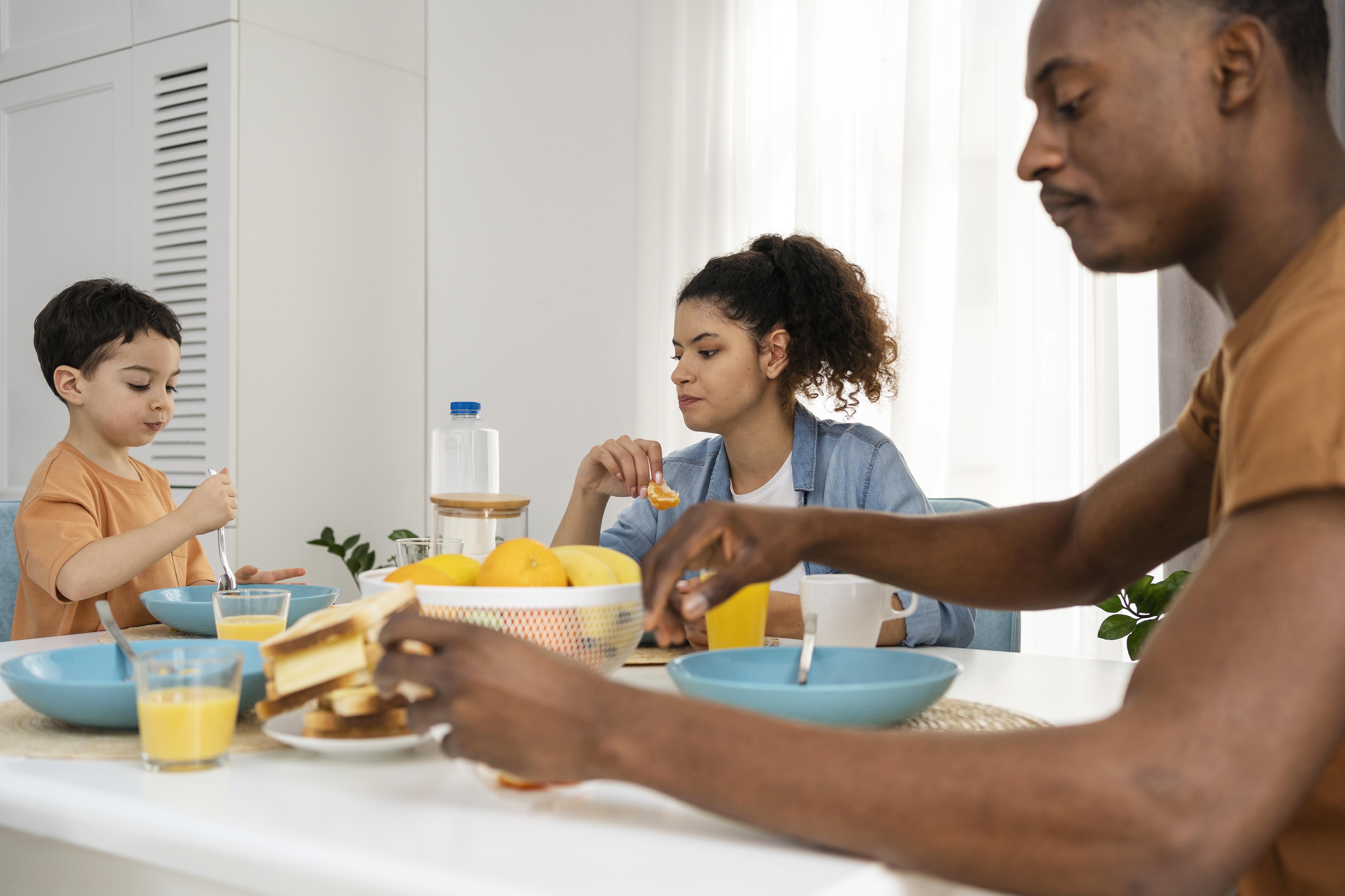 A family sharing a quiet breakfast moment together